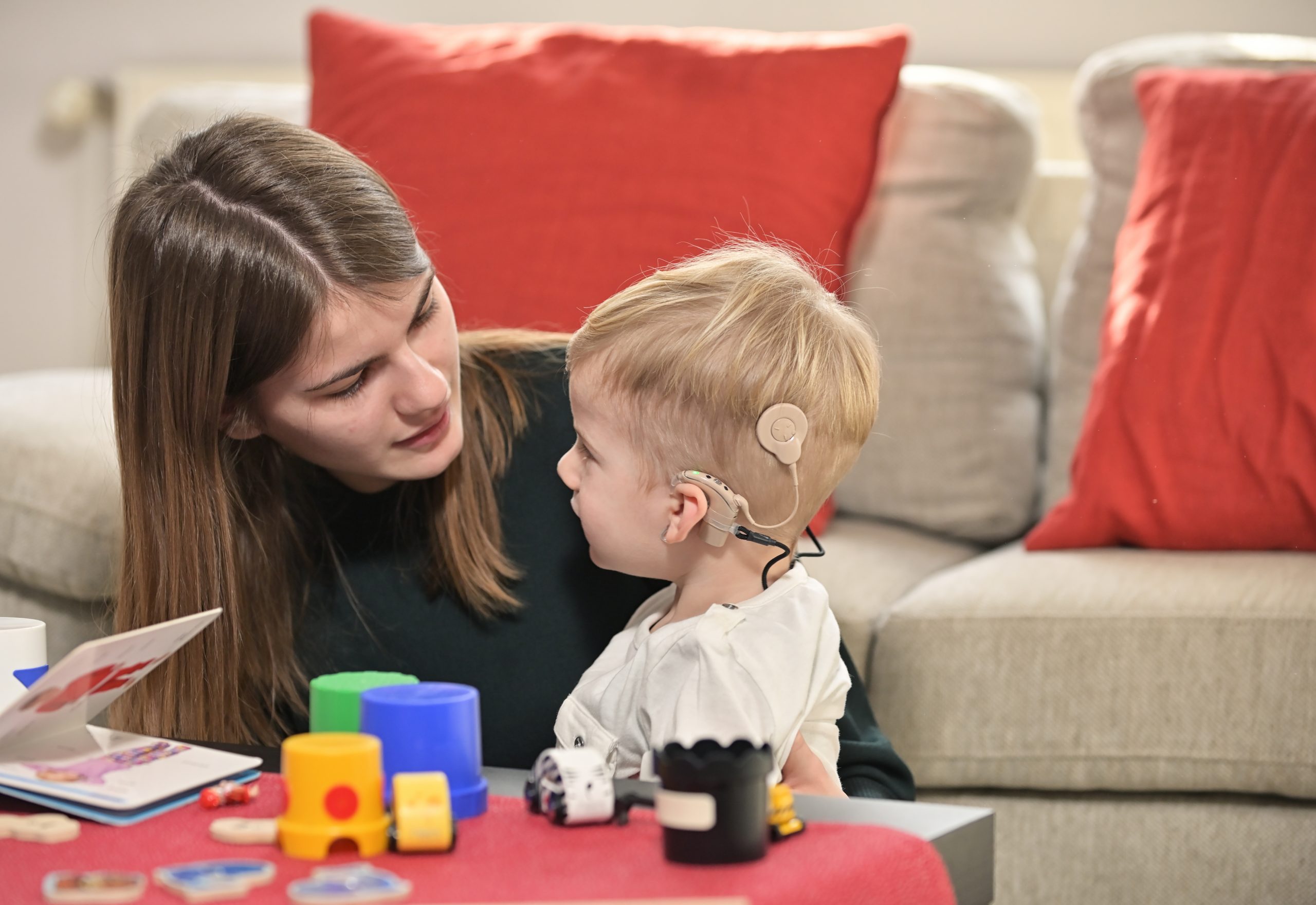 a boy with a hearing aids and cochlear implants
